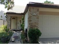 Charming single-story home featuring a brick facade, attached garage, and well-maintained landscaping at 3312 Bridgeford Dr, Orlando, FL 32812