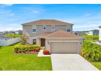 Charming two-story home with a well-maintained lawn and colorful landscaping at 356 Quarry Rock Cir, Kissimmee, FL 34758