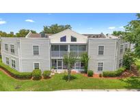 Charming condo featuring a screened porch and manicured lawn, perfect for relaxing outdoors at 3900 Southpointe Dr # 127, Orlando, FL 32822