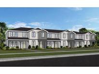 Attractive townhome with a landscaped front yard and neutral color palette at 4564 Maple Waltz Aly, Clermont, FL 34714