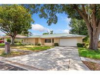 Charming single-story home with a metal roof, mature trees, and a two-car garage at 611 Lakespur Ln, Altamonte Springs, FL 32714