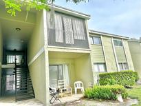 Two-story condo featuring an outdoor patio with chairs and second story screened in porch at 912 Lake Destiny Rd # F, Altamonte Springs, FL 32714