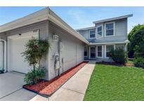 Charming two-story home featuring a well-maintained front yard and an attached garage at 950 Vanessa Ct # F, Port Orange, FL 32127