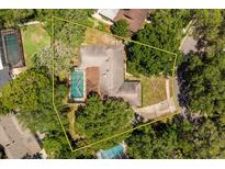 Overhead view of property with pool and bordered property lines nestled among lush green trees at 112 Brandywine Ln, Longwood, FL 32779