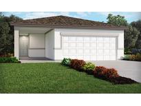 Charming single-story home with a clean white exterior, attached garage, and well-manicured front lawn with colorful shrubs at 1125 Cumberland Trail Dr, Lake Hamilton, FL 33851