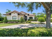 Charming single-story home with a tile roof, a brick driveway, and well-manicured landscaping at 1741 Palmer Ave, Winter Park, FL 32789