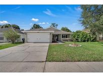 Charming single-story home with a well-maintained front yard and attached two-car garage at 2028 Donegan Pl, Orlando, FL 32826