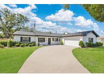 Charming single-story home with a long driveway, well-manicured lawn, and neat landscaping at 2460 Worthington Rd, Maitland, FL 32751