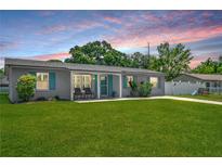 Charming single-story home featuring a lush green lawn and inviting front porch at 2471 Greenwood St, Deltona, FL 32738