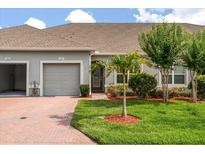 Charming single-story home featuring a well-manicured lawn, brick walkway, and attached two-car garage at 3007 Caneel St, Winter Haven, FL 33884
