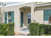 Inviting front entrance featuring a covered porch and well-manicured landscaping at 316 Primrose Dr, Davenport, FL 33837