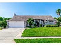 Charming single-story home with a well-manicured lawn and a two-car garage at 341 Sprucewood Rd, Lake Mary, FL 32746