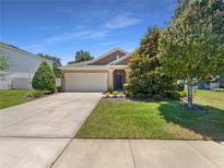 Charming single-story home with well-maintained landscaping and a spacious two-car garage at 4010 Brookshire Cir, Eustis, FL 32736