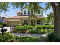 Charming two-story home featuring a landscaped front yard and inviting front porch at 402 S Lake Victoria Cir, Deland, FL 32724