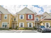 Inviting two-story townhouse with neutral color palette and attached front-entry parking at 7572 Sunny Dreams Ln, Kissimmee, FL 34747
