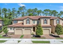 Charming townhome with a tile roof and well-manicured landscaping at 8215 Roseville Blvd, Davenport, FL 33896