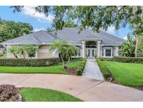 Beautiful one-story home featuring mature landscaping and a stone walkway leading to the front door at 8713 S Bay Dr, Orlando, FL 32819