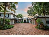 Stunning estate home with manicured landscaping, circular driveway, and attached garages at 9724 Chestnut Ridge Dr, Windermere, FL 34786