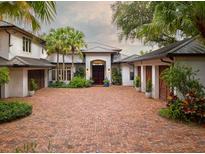 Stunning home featuring a brick driveway, lush landscaping, and a grand entrance at 9724 Chestnut Ridge Dr, Windermere, FL 34786