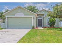 Charming single-story home with a well-manicured lawn and an attached two-car garage at 12020 Philbrook Ct, Orlando, FL 32825