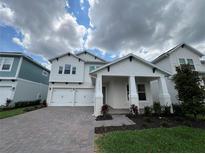 Stunning two-story home with a two car garage and a beautifully landscaped front yard at 13081 Sunrise Harvest Dr, Winter Garden, FL 34787