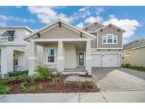 Charming two-story home with a well-manicured front yard and a two-car garage at 13081 Sunrise Harvest Dr, Winter Garden, FL 34787