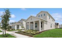 Charming two-story home showcasing an attached garage, manicured lawn, and inviting curb appeal at 13175 Telsen St # 40, Winter Garden, FL 34787