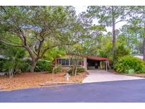 Charming single-story home featuring a well-maintained front yard with mature trees and a long driveway at 149 E Plantation Blvd, Lake Mary, FL 32746