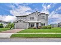 Beautiful two-story home with a well-manicured lawn, an attached two-car garage, and a charming covered entryway at 17537 Sailfin Dr, Orlando, FL 32820