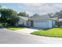 Charming single-story home with well-maintained landscaping and an attached two-car garage on a sunny day at 1754 Torrington Cir, Longwood, FL 32750