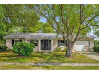 Charming single-story home with mature landscaping and a metal roof at 2357 E Dana Dr, Deltona, FL 32738