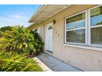 Inviting front entrance with vibrant greenery and a white door, enhancing curb appeal at 245 Amador Cir, Orlando, FL 32810