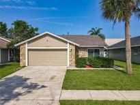 Charming single Gathering home with stone accents and a manicured lawn, perfect for a relaxing outdoor space at 293 Drosdick Dr, Casselberry, FL 32707