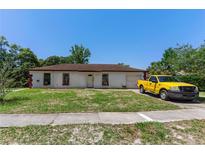 Modest single-story home with a small front yard and attached garage, awaiting personalized updates at 315 Panama Cir, Winter Springs, FL 32708