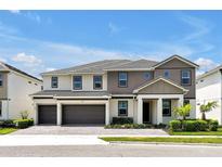 Beautiful two-story home showcasing neutral paint, a three-car garage, manicured landscaping, and a tile roof at 3860 Sonoma Blvd, Kissimmee, FL 34741