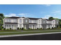 Row of modern townhomes with gray and white siding and manicured lawns at 4568 Maple Waltz Aly, Clermont, FL 34714