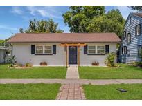 Charming single-story home with a light-brick exterior, well-manicured lawn, and inviting entrance at 612 Florida Ave, St Cloud, FL 34769