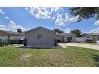 Charming single-story home featuring a well-manicured lawn and brick exterior, perfect for suburban living at 6152 Roxburg Ave, Orlando, FL 32809