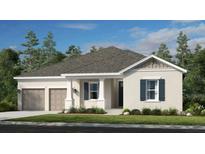Charming one-story home with a two-car garage, well manicured lawn, and inviting front porch at 16041 Honey Harvest St, Winter Garden, FL 34787