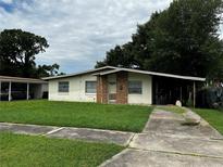 Charming single-story home with a brick entryway and a well-maintained front lawn, offering a welcoming curb appeal at 1822 Williams Manor Ave, Orlando, FL 32811