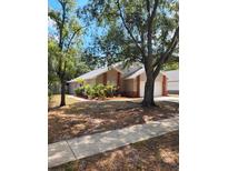 Charming single-story home with manicured landscaping and mature trees at 2723 Talladega Dr, Orlando, FL 32826