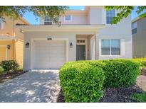 Charming home featuring an attached garage and well-manicured front yard at 2985 Buccaneer Palm Rd, Kissimmee, FL 34747
