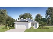 Charming single-story home with a well-maintained lawn, attached garage, and blue accent door at 3226 Ne 35Th Pl, Ocala, FL 34479