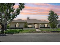 Charming single-story home with brick and concrete exterior, manicured landscaping, and a tile roof at 356 N Spaulding Cv, Lake Mary, FL 32746