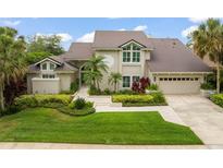 Stunning two-story home featuring a well-manicured lawn, mature landscaping, and a charming front entrance, offering great curb appeal at 4536 N Landmark Dr, Orlando, FL 32817