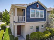 Charming two-story home featuring a blue accent wall, covered porch, and beautifully landscaped front yard at 4630 Socrates Way, Sanford, FL 32773