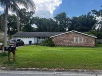 Charming single-story home featuring a well-maintained lawn and a mix of brick and siding exterior at 5 Riverdale Ave, Ormond Beach, FL 32174