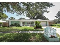 Charming home with a well-maintained lawn, a decorative mailbox, and a welcoming, quaint front porch at 645 Peachwood Dr, Altamonte Springs, FL 32714
