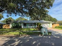 Charming single-story home with a well-manicured lawn, mature trees, and a quaint mailbox at 645 Peachwood Dr, Altamonte Springs, FL 32714