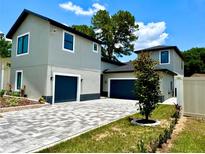 Charming home exterior featuring a paved driveway, well-kept lawn, and modern two-story design at 107 Grove St, Orlando, FL 32835